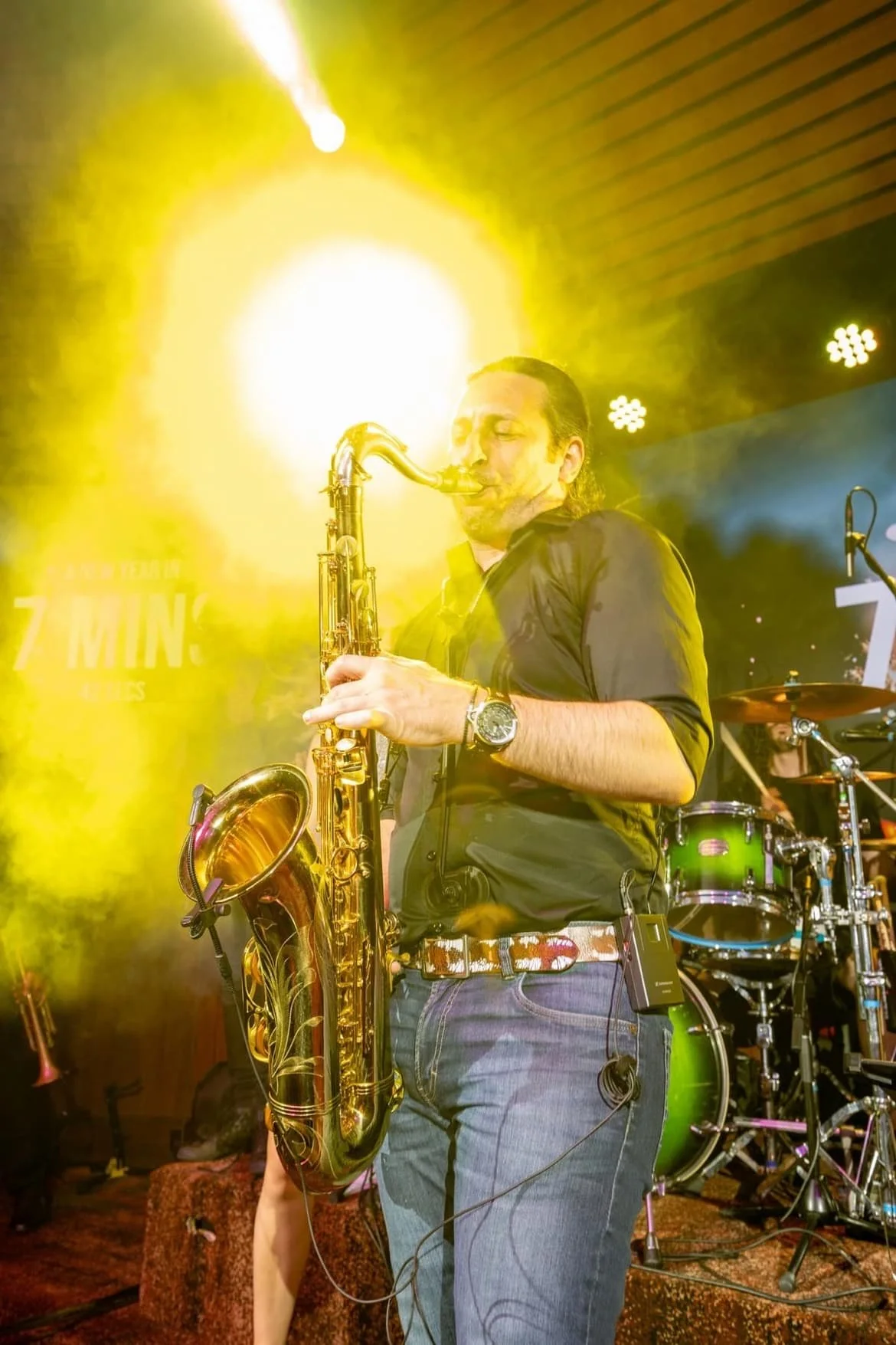 Saxophonist under stage lights