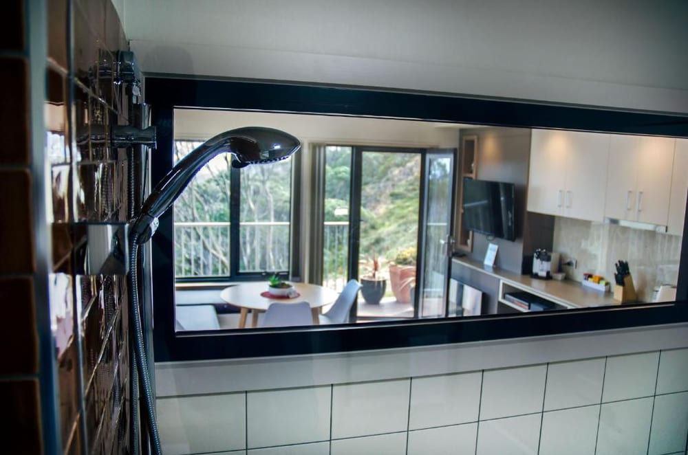 A Mountain Dreaming apartment interior, the window framing the snow gums and mountains